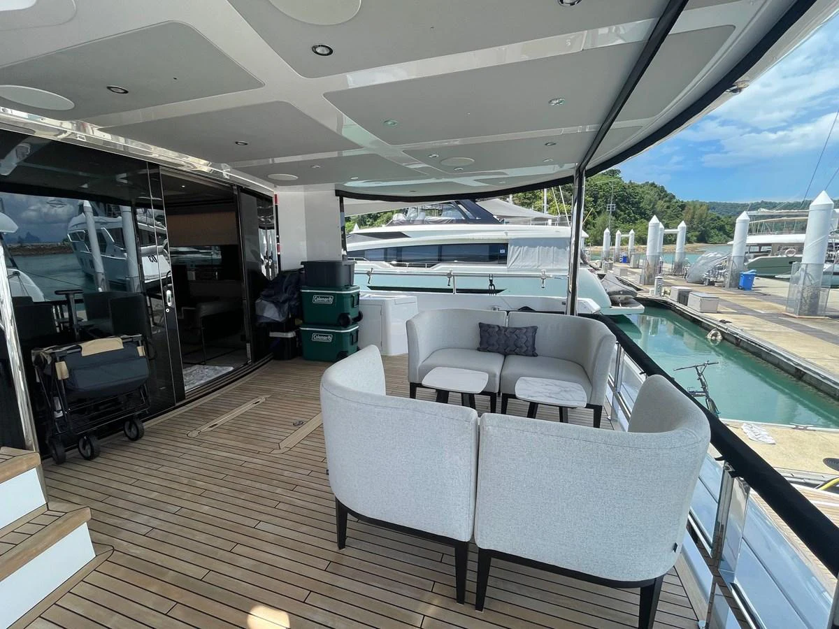 The aft deck offers a comfortable seating area with a view of the marina. aboard SU Yacht for Sale