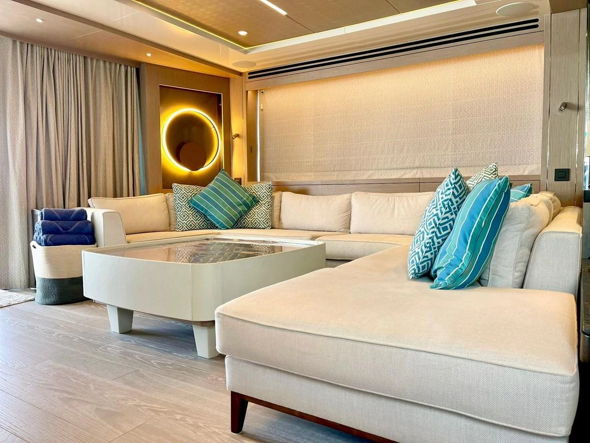 The salon features a spacious and elegant seating area with modern decor and ample natural light. aboard SU Yacht for Sale