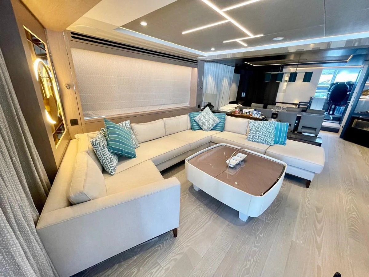 The salon features a spacious and elegant seating area with modern decor and ample natural light. aboard SU Yacht for Sale