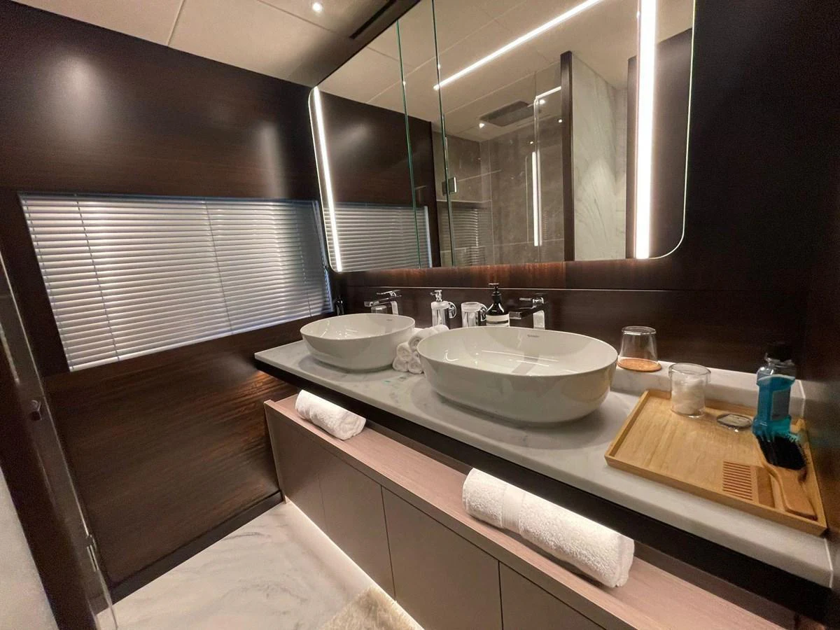 A luxurious yacht bathroom featuring dual sinks and modern fixtures. aboard SU Yacht for Sale