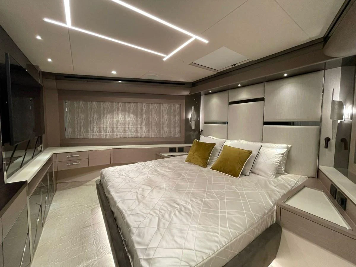 The master stateroom features a luxurious bed with modern lighting and elegant decor. aboard SU Yacht for Sale