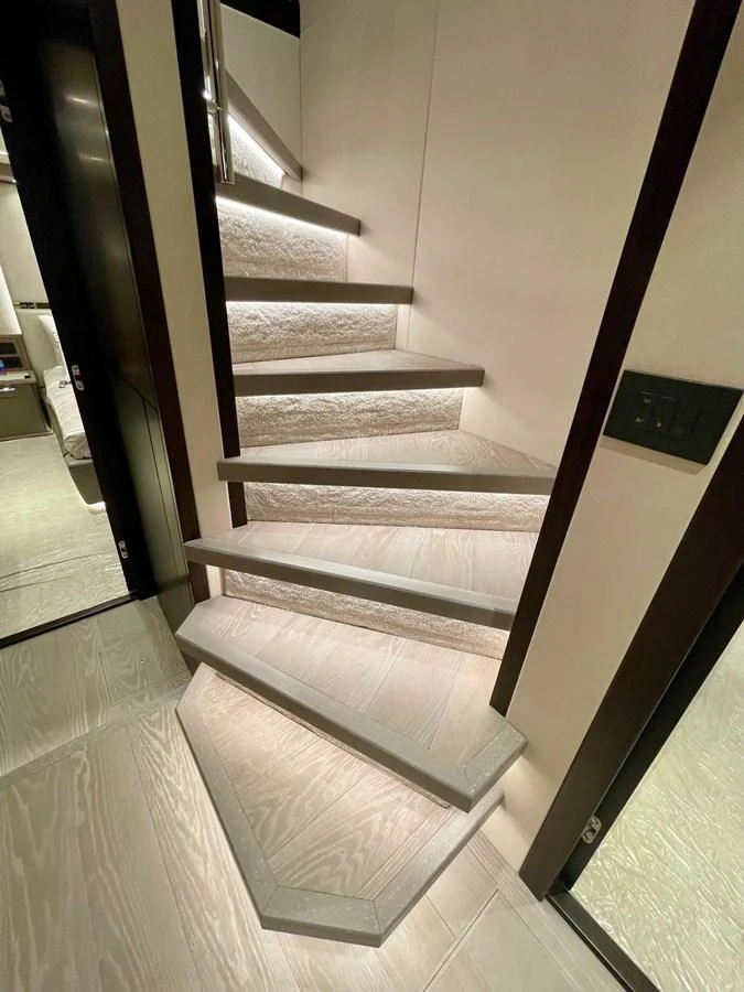 A modern and elegantly lit staircase inside the yacht. aboard SU Yacht for Sale