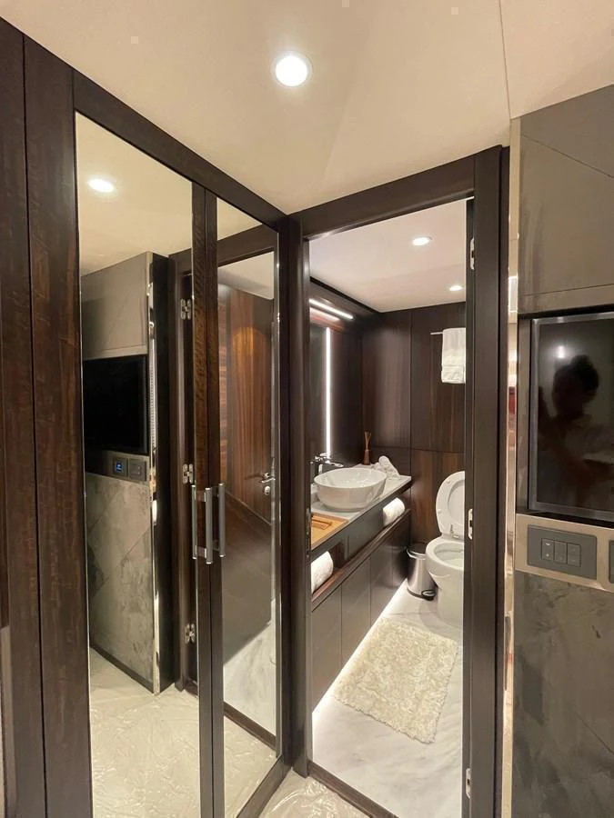 The yacht's bathroom features elegant wood paneling and modern fixtures. aboard SU Yacht for Sale