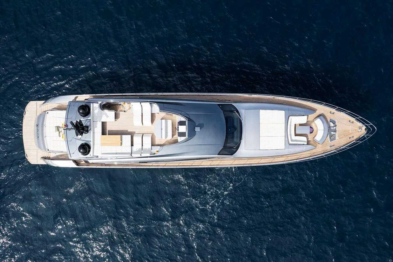 A sleek, modern yacht is captured from an aerial view, showcasing its elegant design and spacious deck areas. aboard GRACE Yacht for Sale