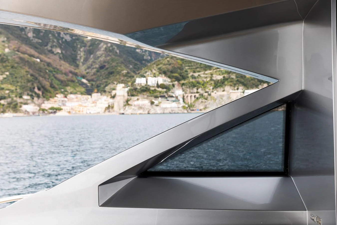 a window with a view of a town and water aboard GRACE Yacht for Sale