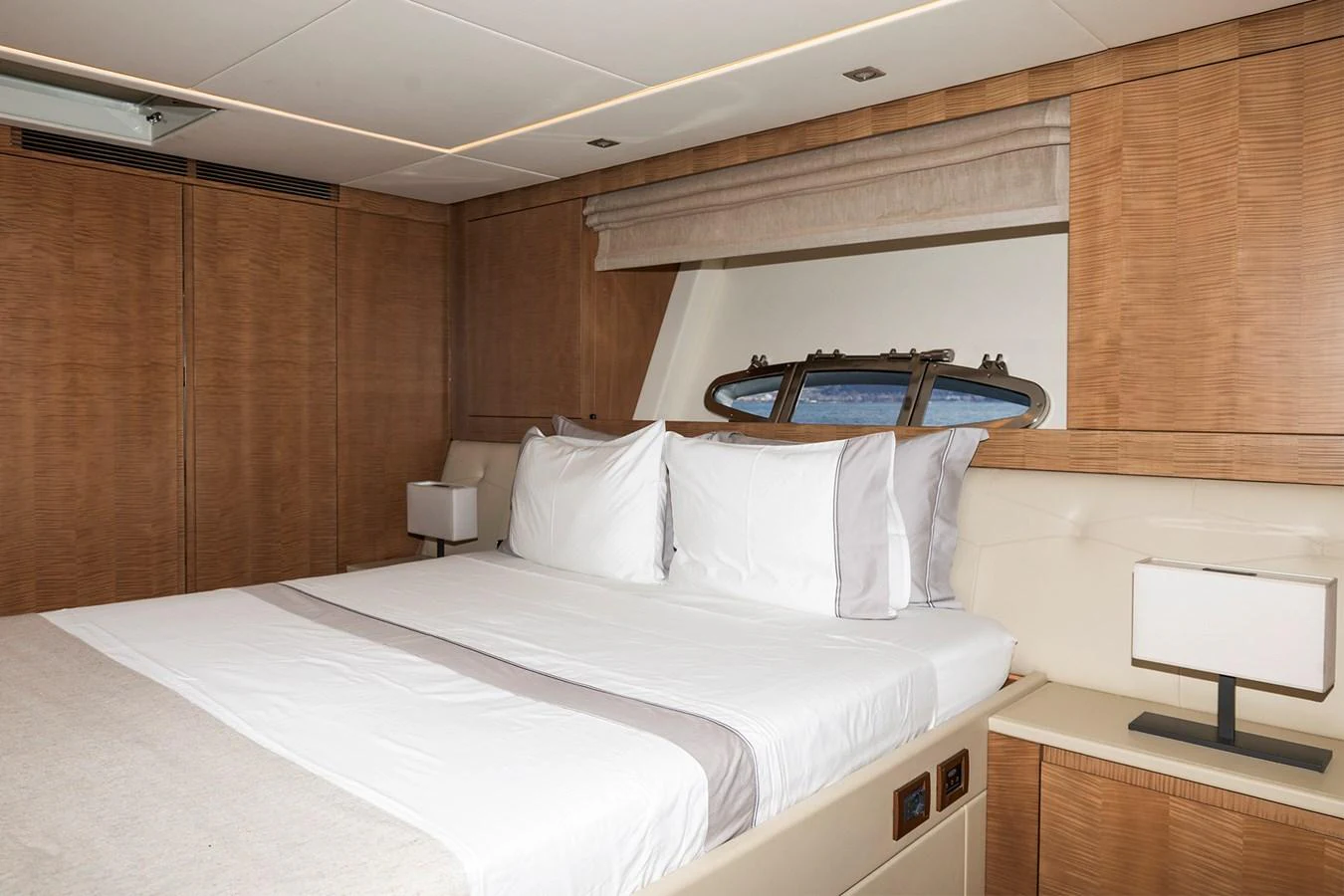 a bed with white sheets aboard GRACE Yacht for Sale