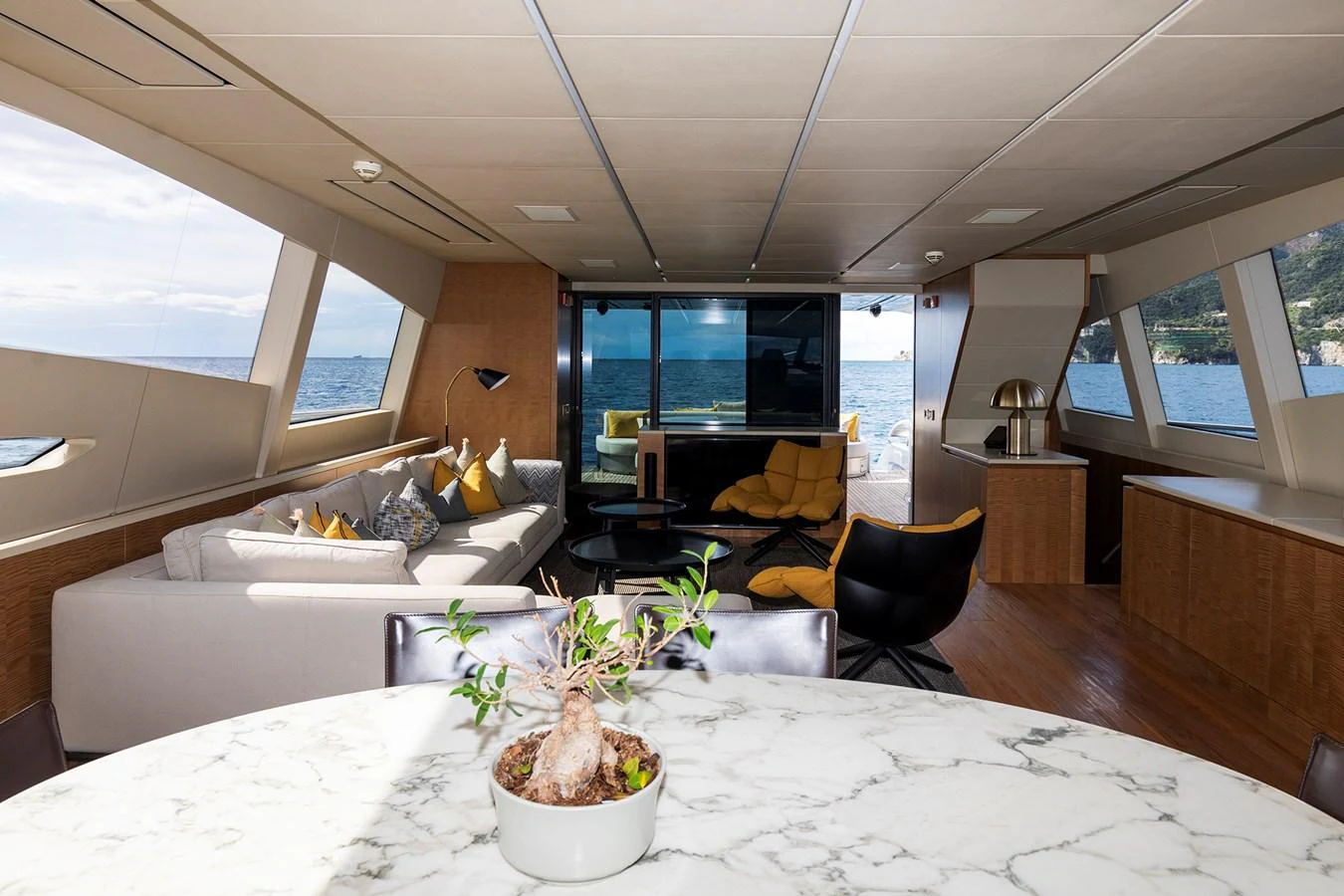 a large room with a table and chairs aboard GRACE Yacht for Sale