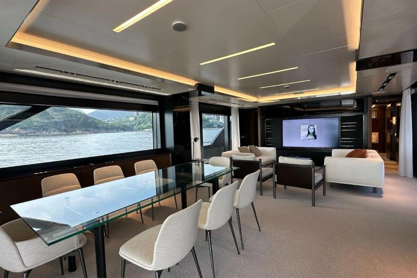 a room with a table and chairs and a tv aboard BELLA DONNA Yacht for Sale