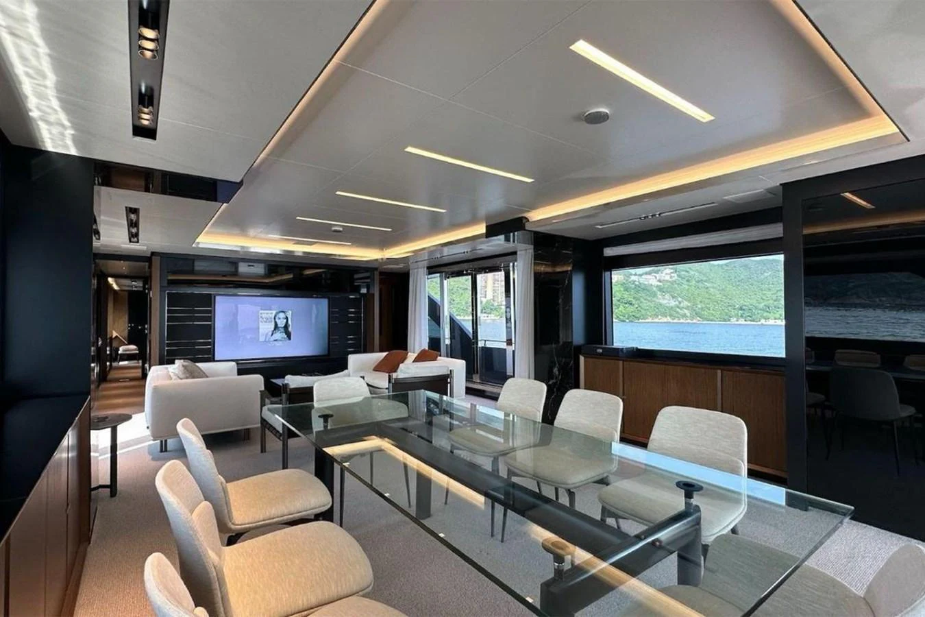 a room with a large table and chairs and a tv aboard BELLA DONNA Yacht for Sale