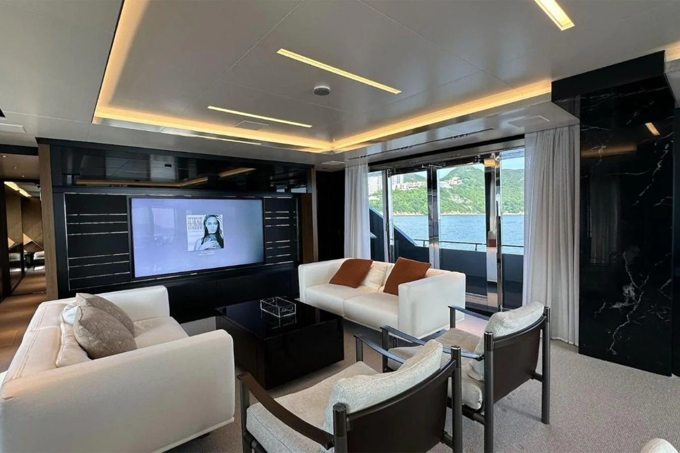 a living room with a large screen aboard BELLA DONNA Yacht for Sale
