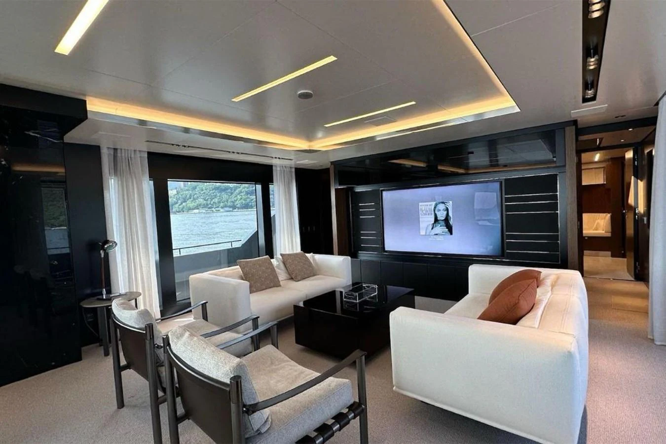 The salon features modern furnishings with ample seating and a large flat-screen TV. aboard BELLA DONNA Yacht for Sale