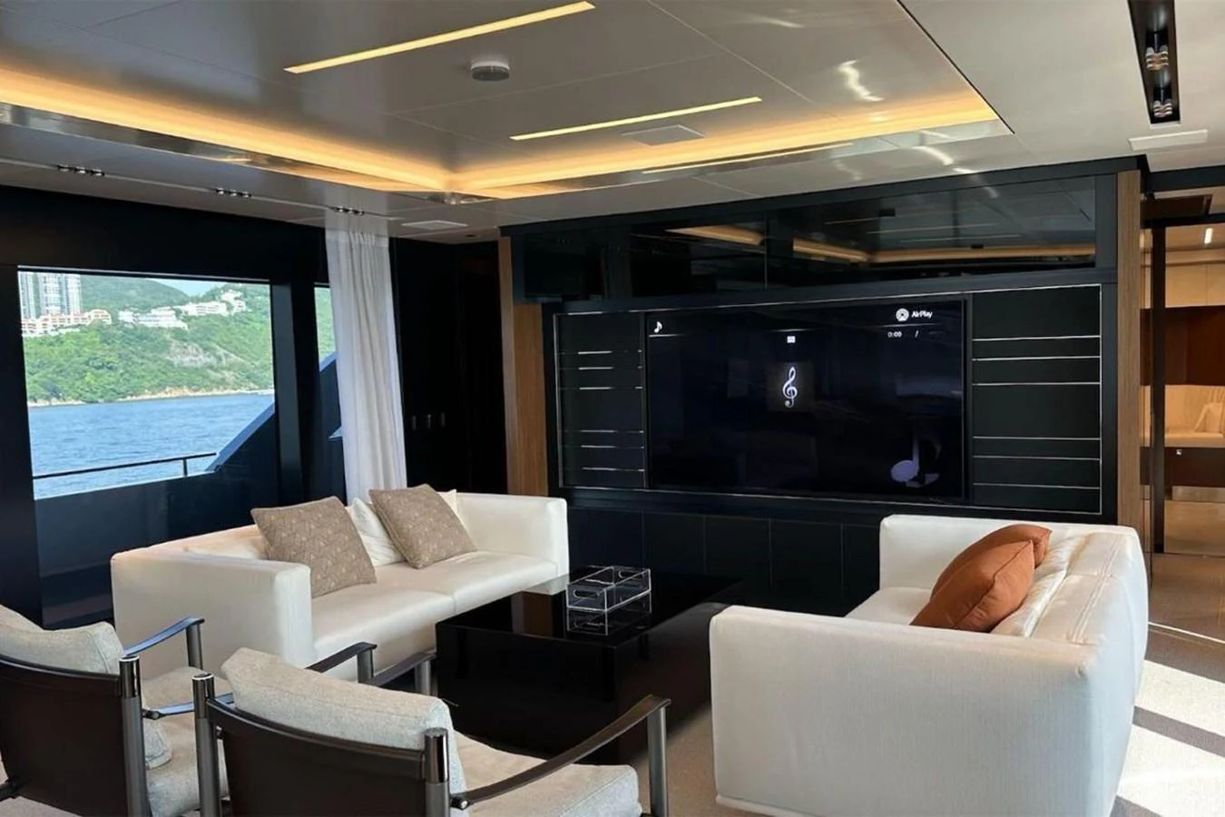 The yacht's salon features modern furnishings with a large flat-screen TV and ample seating. aboard BELLA DONNA Yacht for Sale