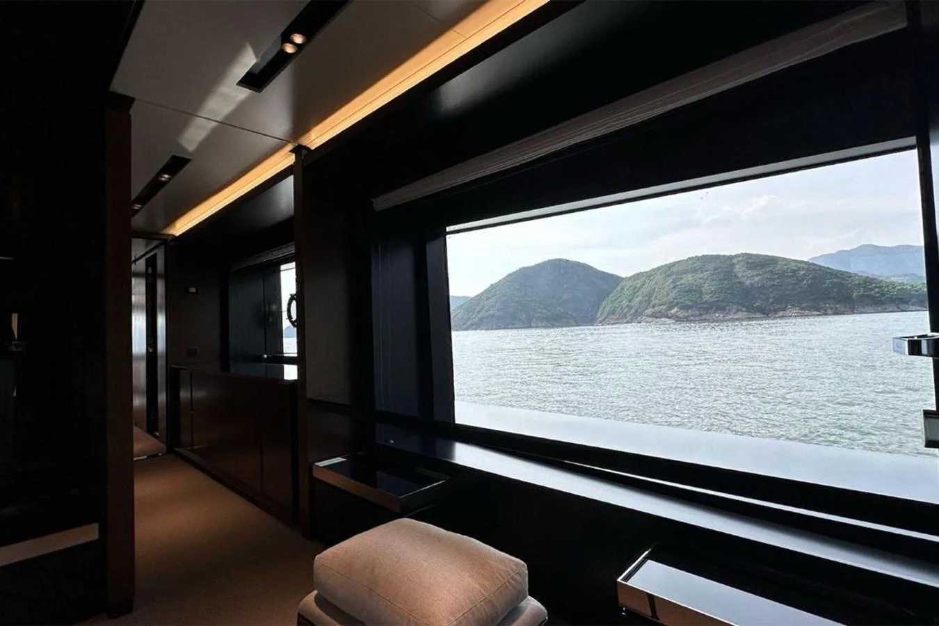 The interior of the yacht features a large window offering a stunning view of the surrounding landscape. aboard BELLA DONNA Yacht for Sale