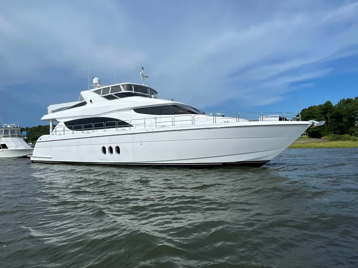 A sleek and modern yacht glides gracefully on calm waters under a clear sky. aboard HOPE Yacht for Sale