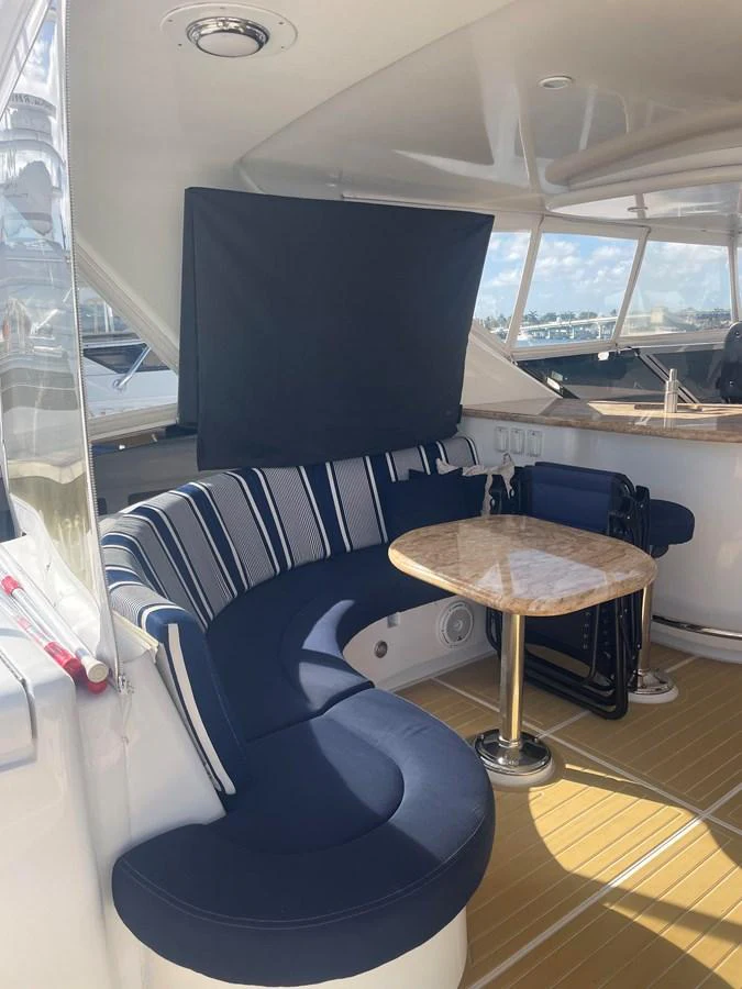a room with a table and a tv aboard HOPE Yacht for Sale