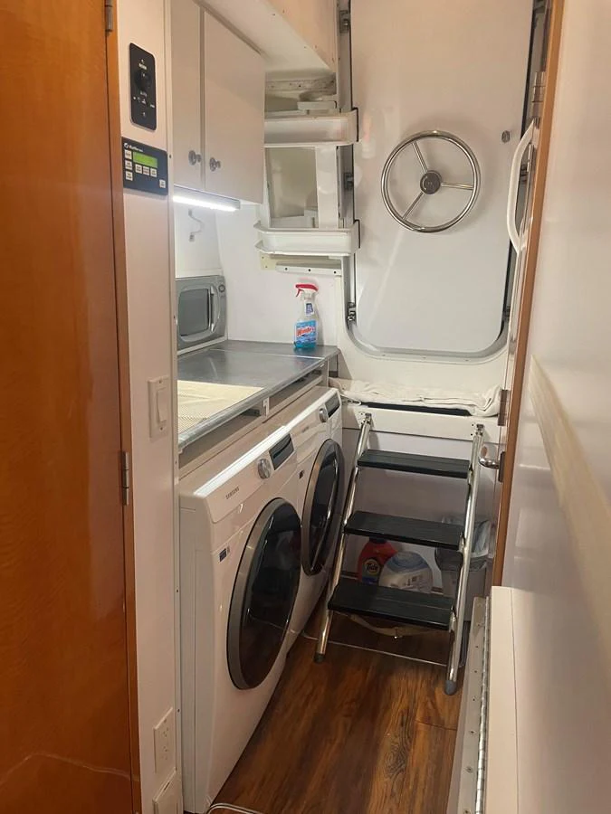 The yacht features a compact and functional laundry room equipped with modern appliances and ample storage. aboard HOPE Yacht for Sale