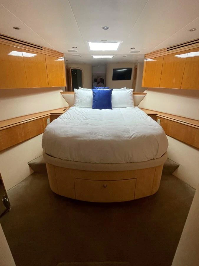 The stateroom features a cozy double bed with elegant wood cabinetry and soft lighting, creating a warm and inviting atmosphere. aboard HOPE Yacht for Sale