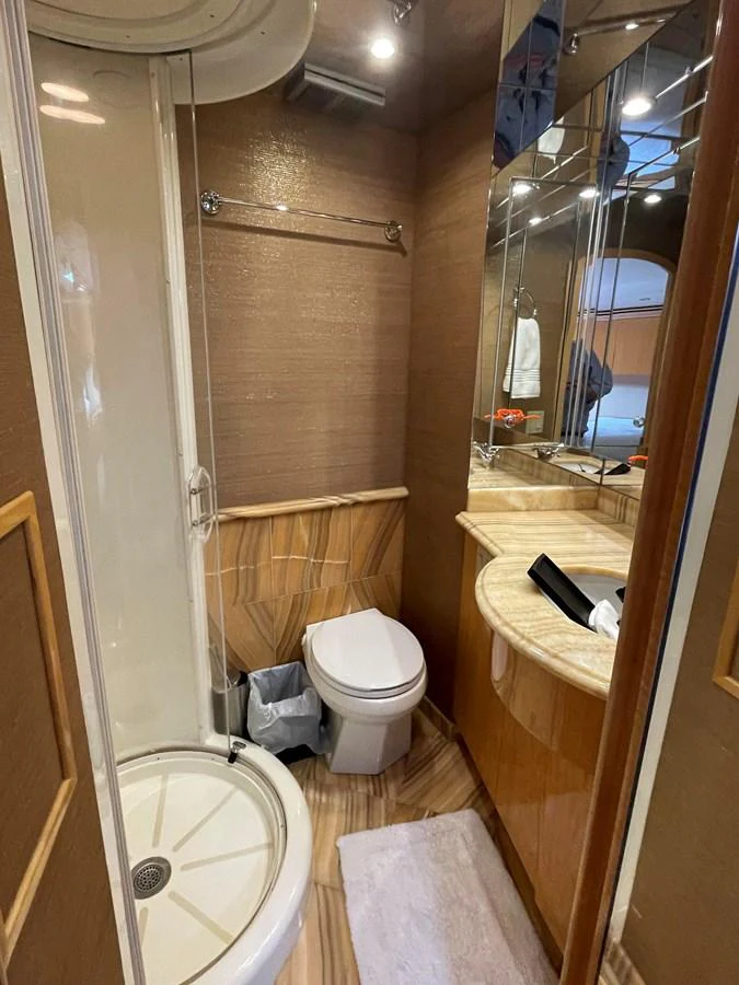 The yacht's bathroom features a compact yet elegant design with a shower, toilet, and vanity area. aboard HOPE Yacht for Sale