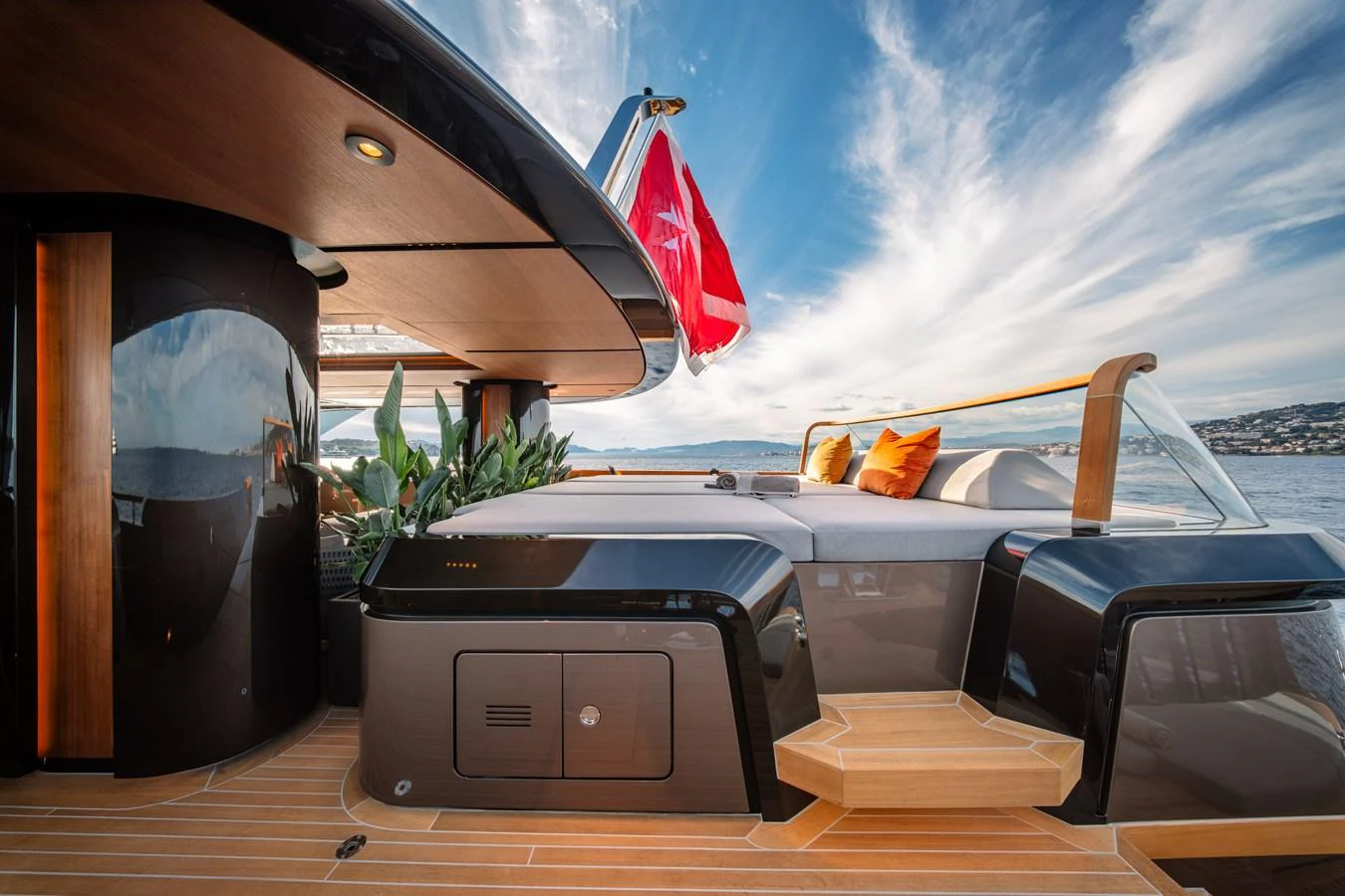 The aft deck of the yacht features a luxurious lounging area with plush cushions and a sleek, modern design. aboard RAJA Yacht for Sale