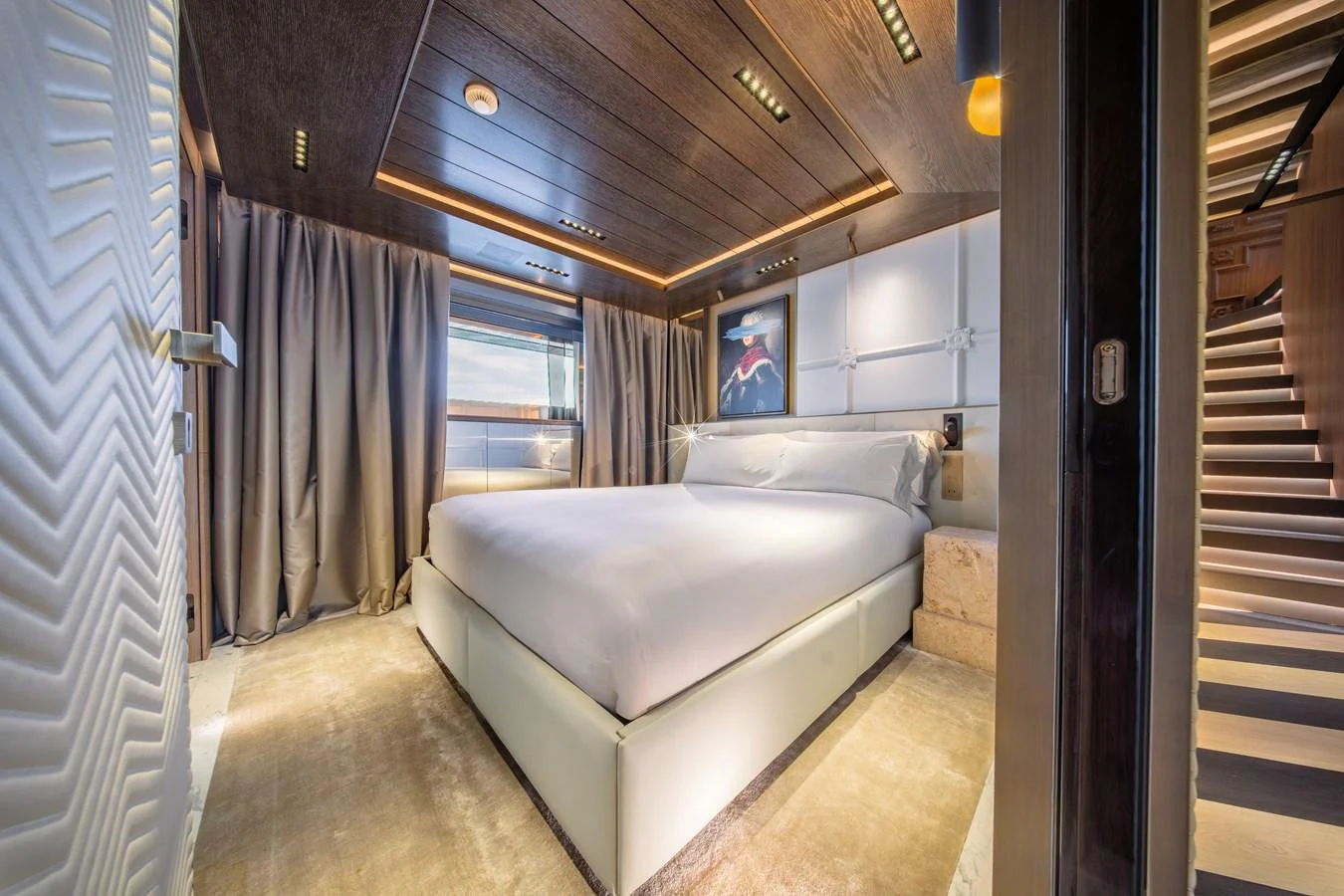 A luxurious stateroom featuring a large bed and elegant decor. aboard RAJA Yacht for Sale