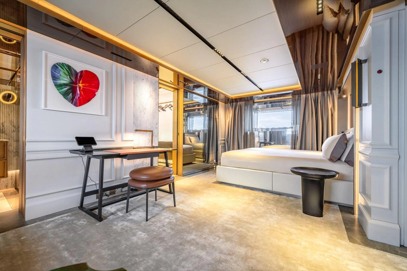 A luxurious stateroom featuring modern decor and ample natural light. aboard RAJA Yacht for Sale