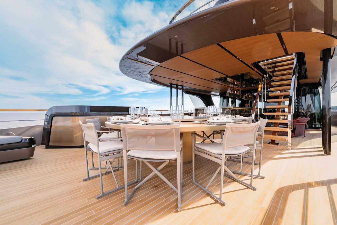 The aft deck features an elegant dining area with a stunning view of the sea. aboard RAJA Yacht for Sale