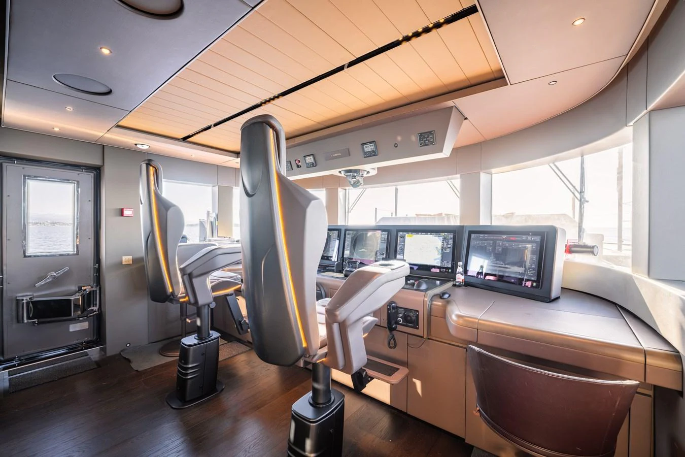 The helm station features advanced navigation equipment and comfortable seating for the captain and crew. aboard RAJA Yacht for Sale