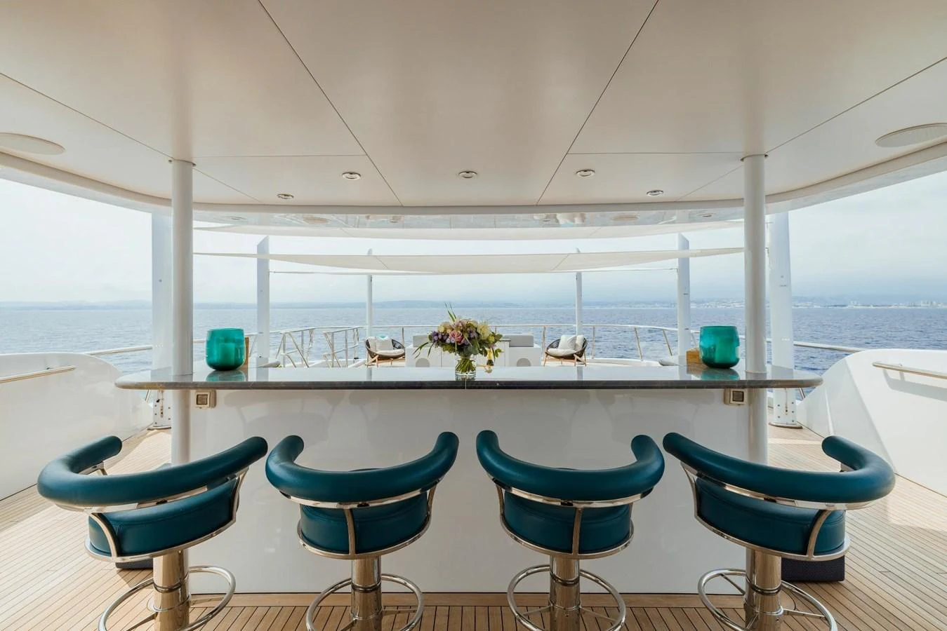 The yacht features a stylish outdoor bar area with comfortable seating and a stunning ocean view. aboard DREAM Yacht for Sale