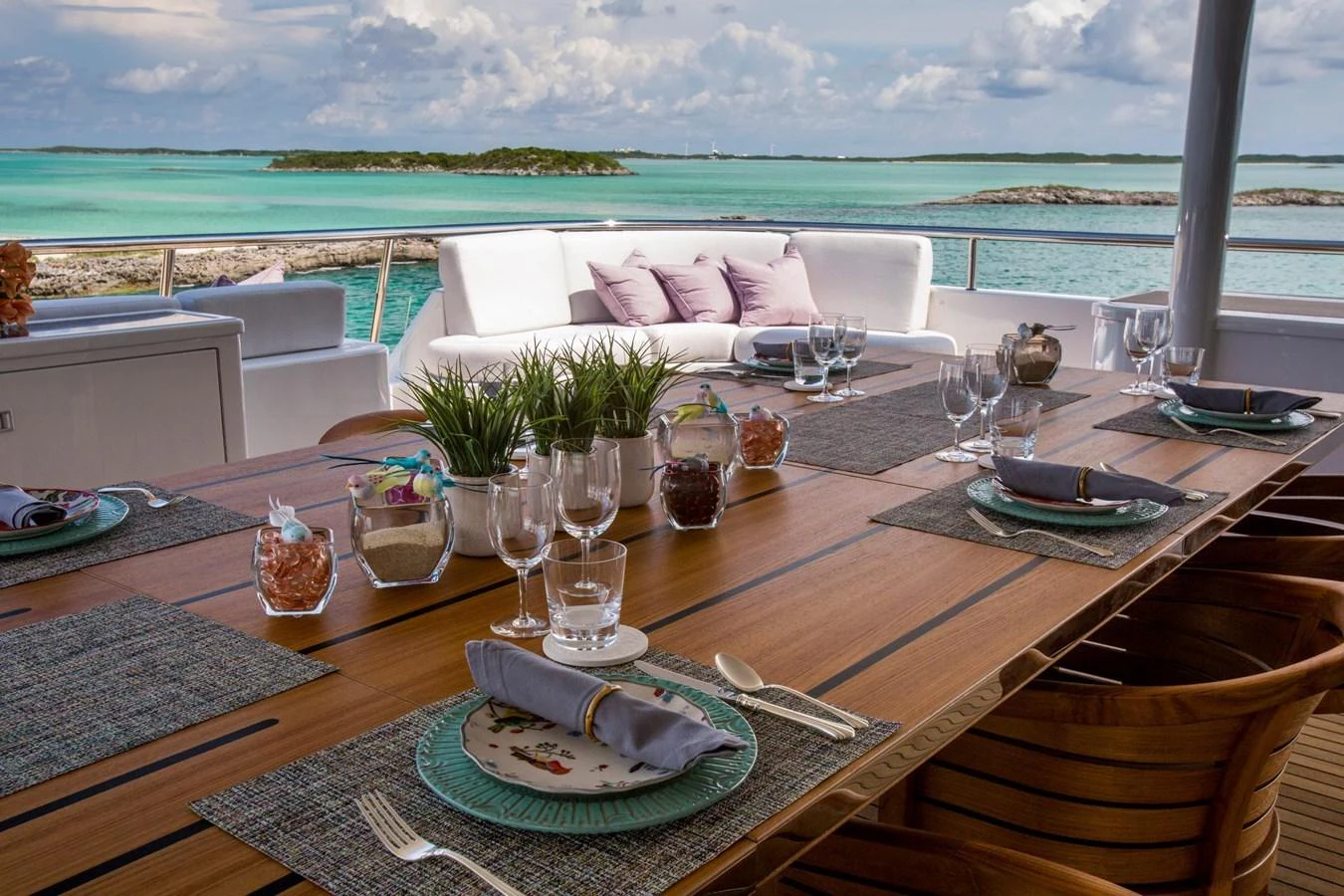 The aft deck offers a beautifully set dining area with stunning ocean views. aboard DREAM Yacht for Sale