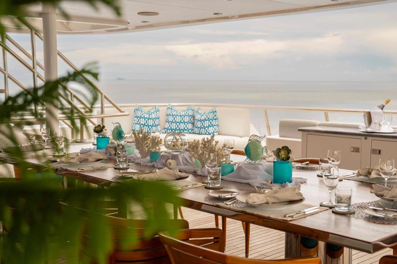 The alfresco dining area offers a beautifully set table with ocean views, perfect for enjoying meals in a serene setting. aboard DREAM Yacht for Sale