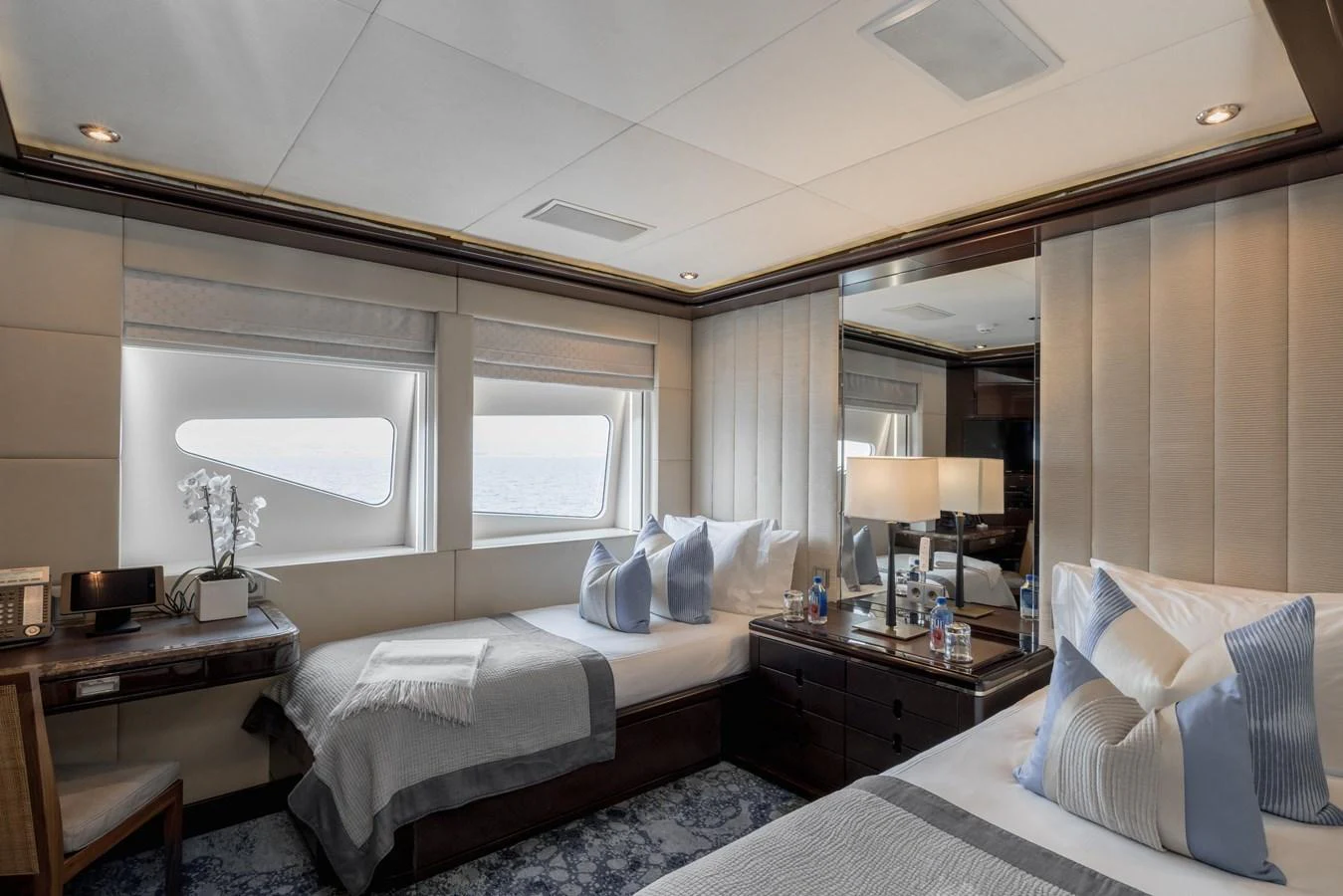 The guest stateroom offers a serene and comfortable space with twin beds and elegant decor. aboard DREAM Yacht for Sale