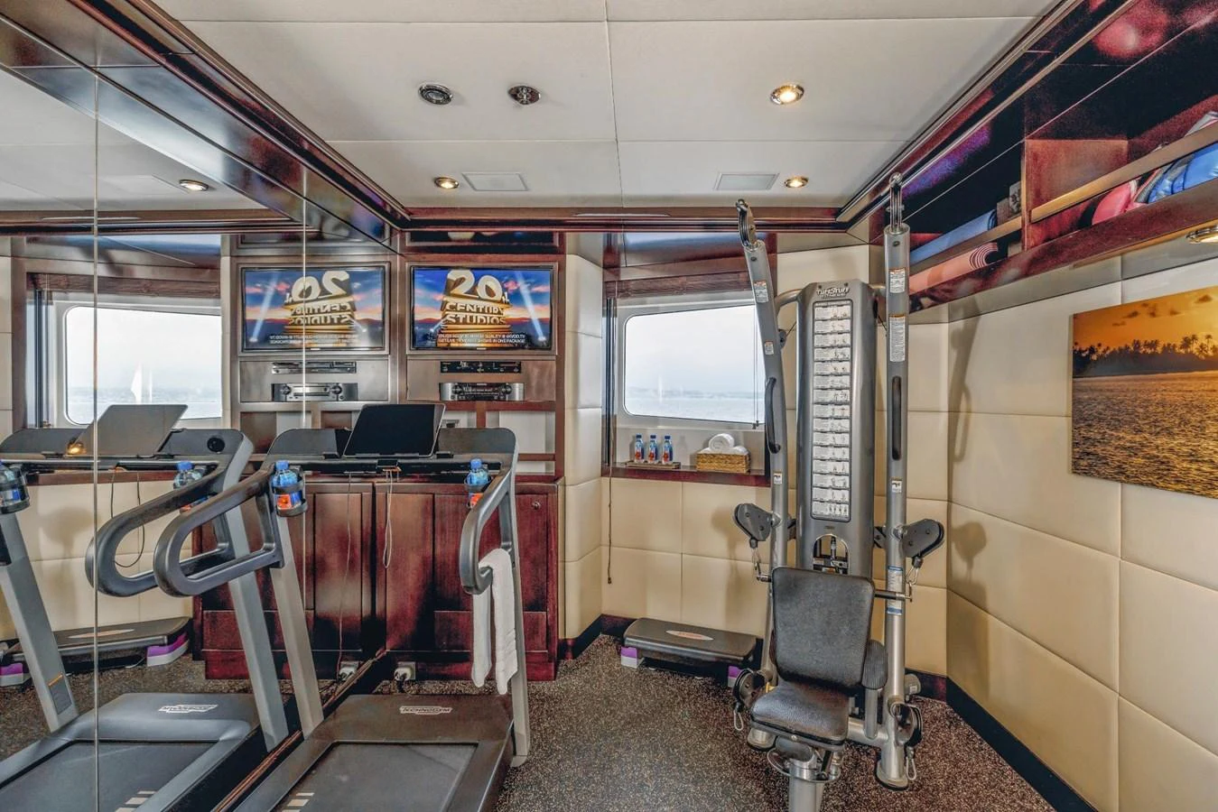 The yacht features a well-equipped gym with modern fitness equipment and a scenic view. aboard DREAM Yacht for Sale