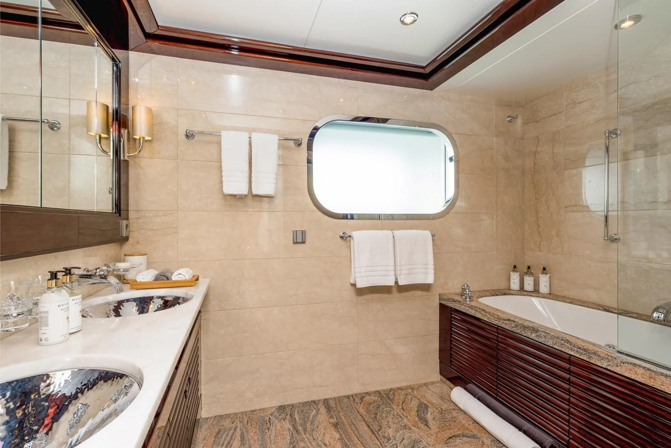The yacht's bathroom features elegant fixtures and a luxurious design with a spacious bathtub and dual sinks. aboard DREAM Yacht for Sale