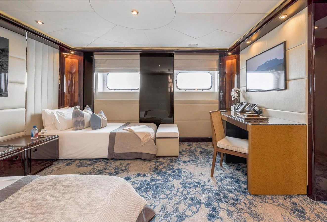 The guest stateroom offers a serene and luxurious retreat with elegant decor and ample natural light. aboard DREAM Yacht for Sale