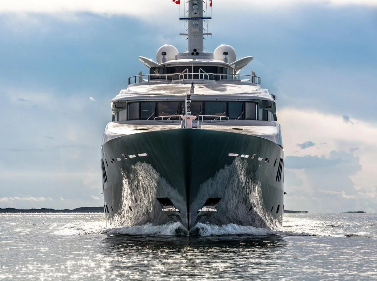 A majestic yacht cuts through the water, showcasing its impressive bow and sleek design. aboard DREAM Yacht for Sale