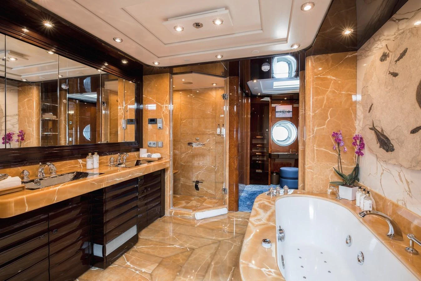 The luxurious bathroom features elegant marble surfaces, a spacious shower, and a jacuzzi tub. aboard DREAM Yacht for Sale