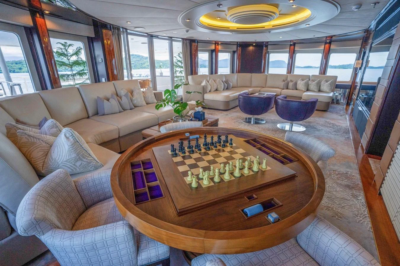 The salon features a luxurious seating area with a chess table, offering a perfect blend of relaxation and entertainment. aboard DREAM Yacht for Sale