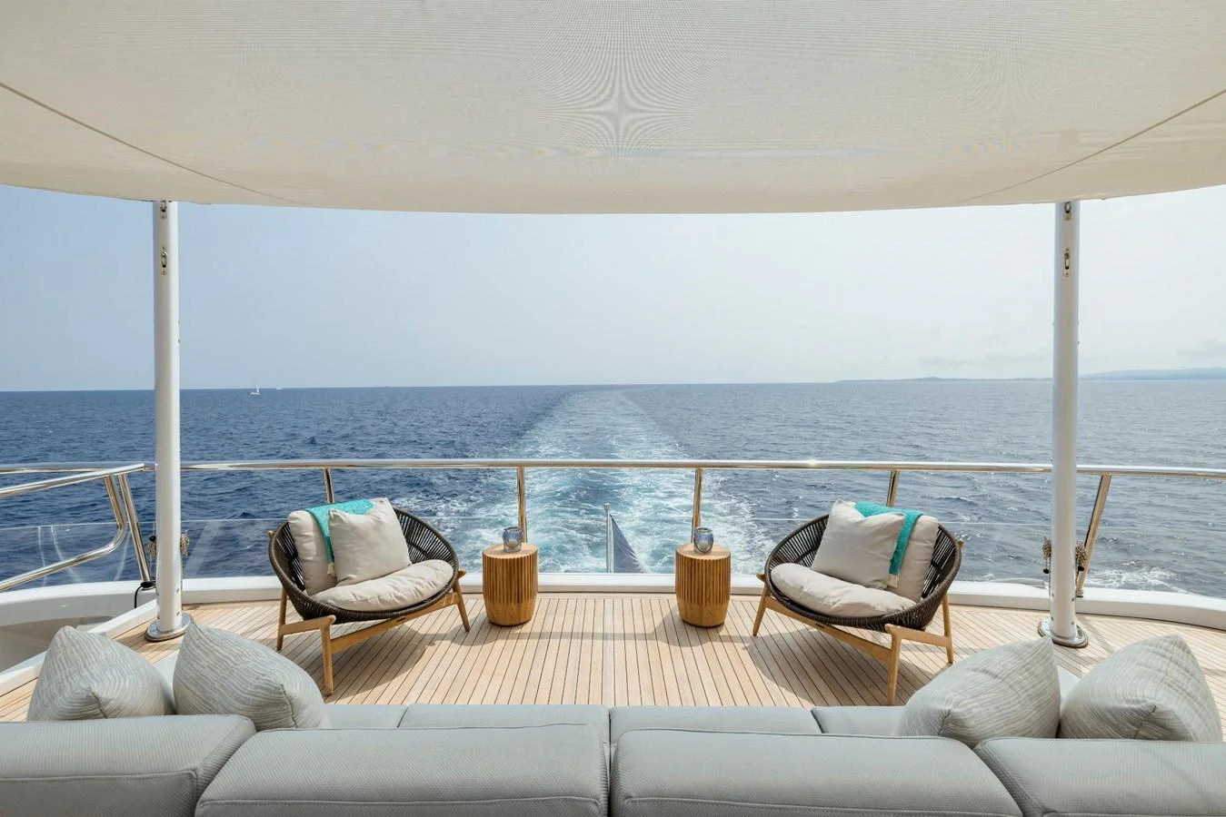 The aft deck offers a serene seating area with stunning ocean views. aboard DREAM Yacht for Sale