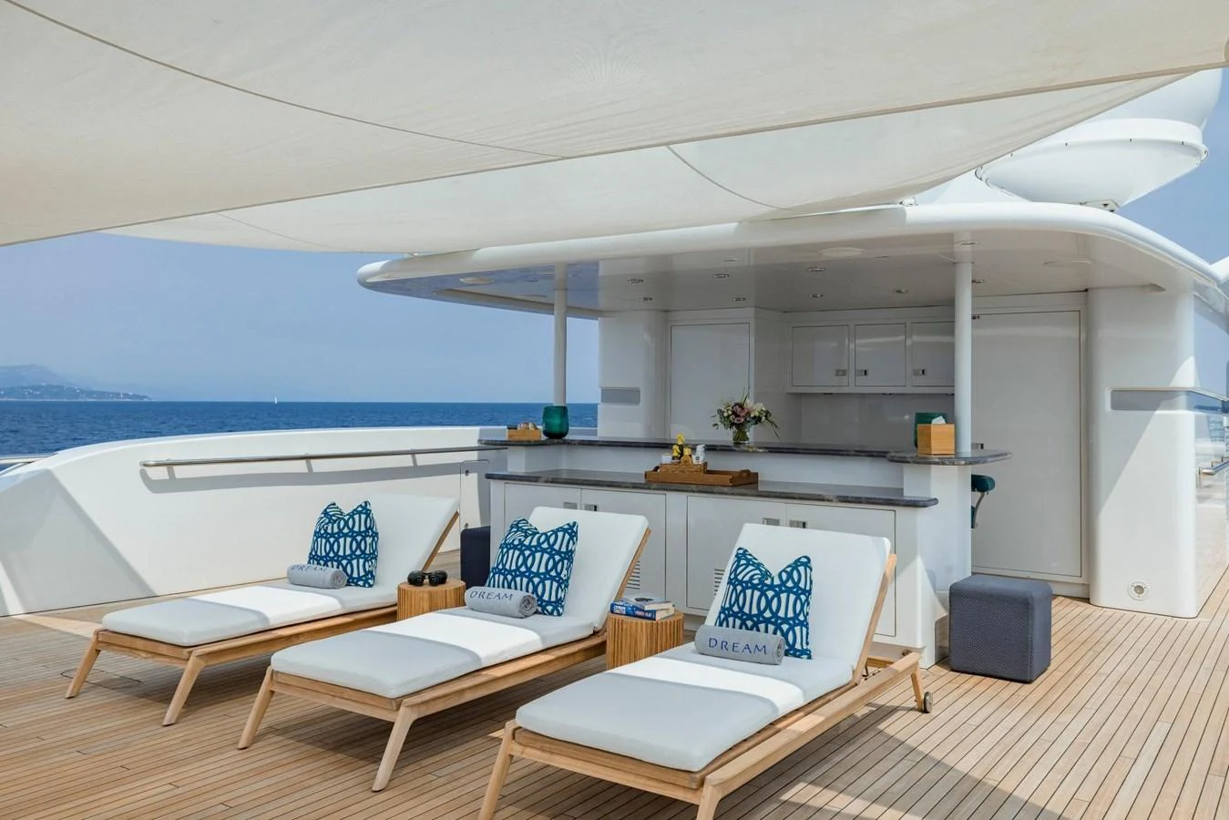 The sundeck features luxurious lounge chairs and a well-equipped bar area, perfect for relaxation and entertaining. aboard DREAM Yacht for Sale