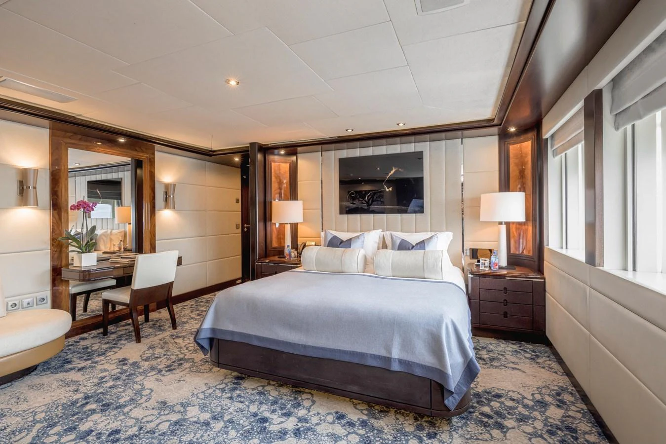The master stateroom features a luxurious bed, elegant decor, and ample natural light. aboard DREAM Yacht for Sale