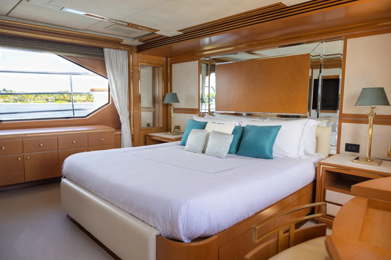 The master stateroom offers a luxurious and serene retreat with elegant wood finishes and a large window providing stunning views. aboard SEA GYPSY Yacht for Sale