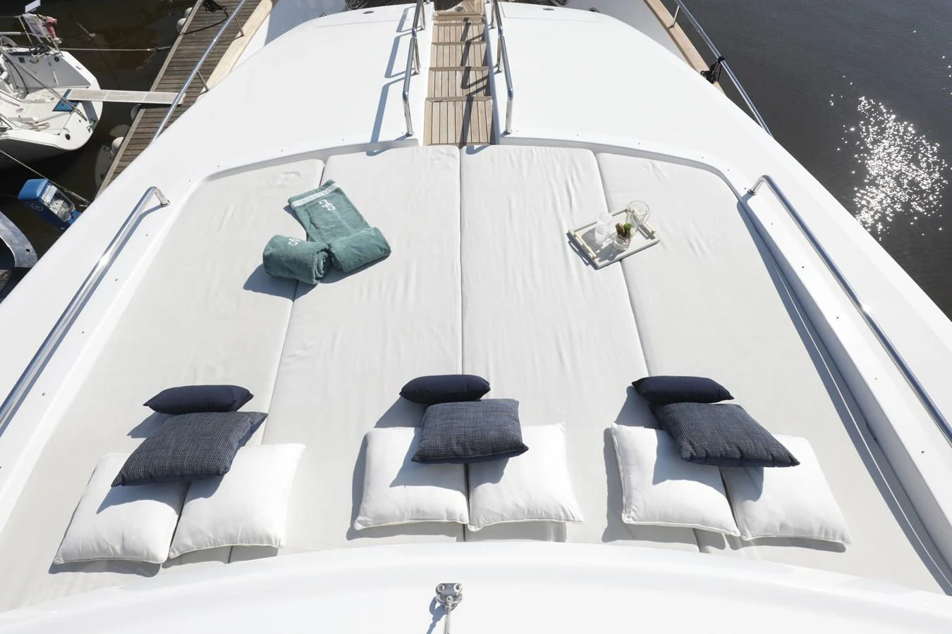 The sundeck offers a luxurious lounging area with plush cushions and towels, perfect for relaxation. aboard SEA GYPSY Yacht for Sale