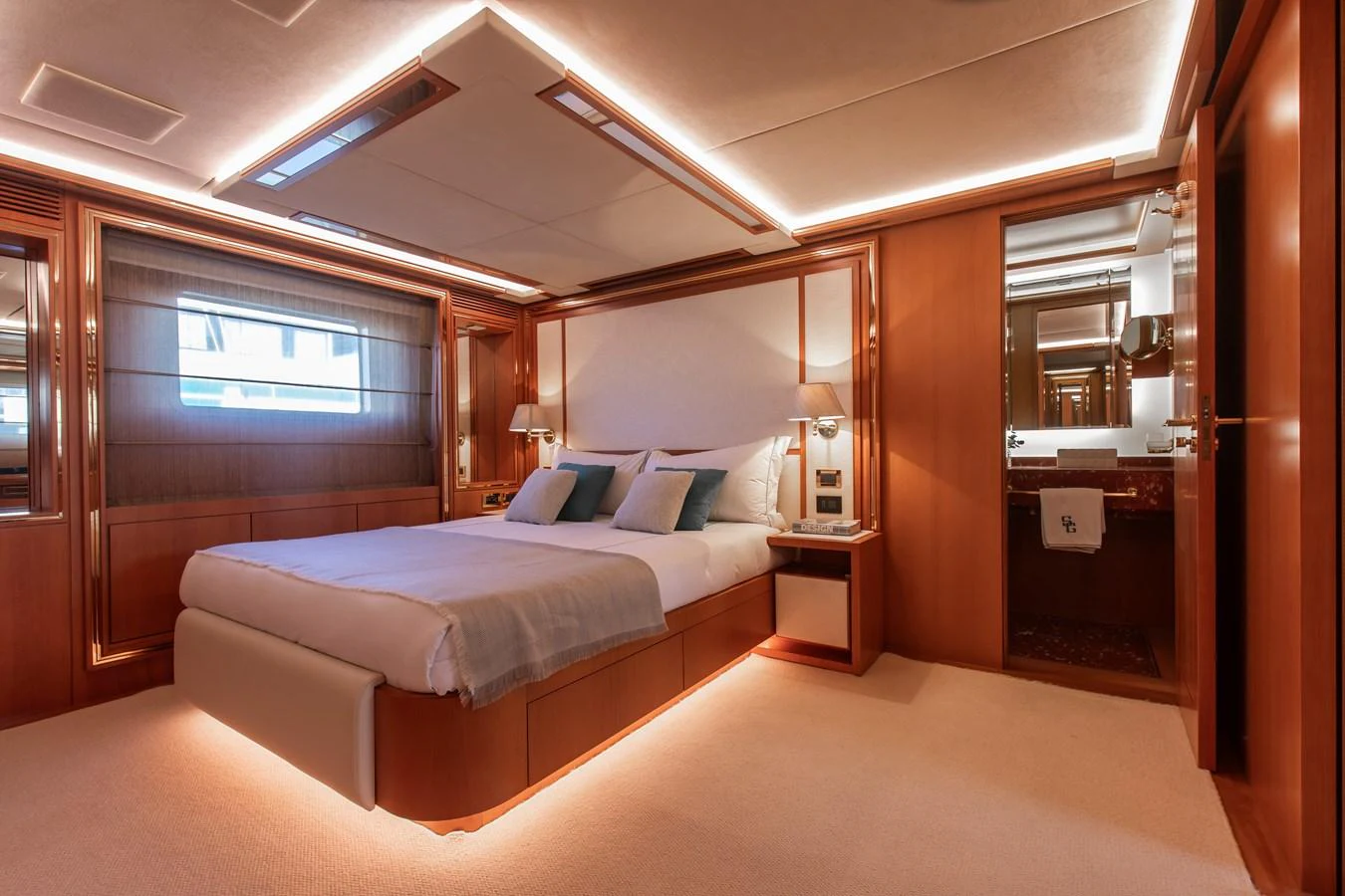 The master stateroom exudes elegance with its plush bedding, warm wood finishes, and ambient lighting. aboard SEA GYPSY Yacht for Sale