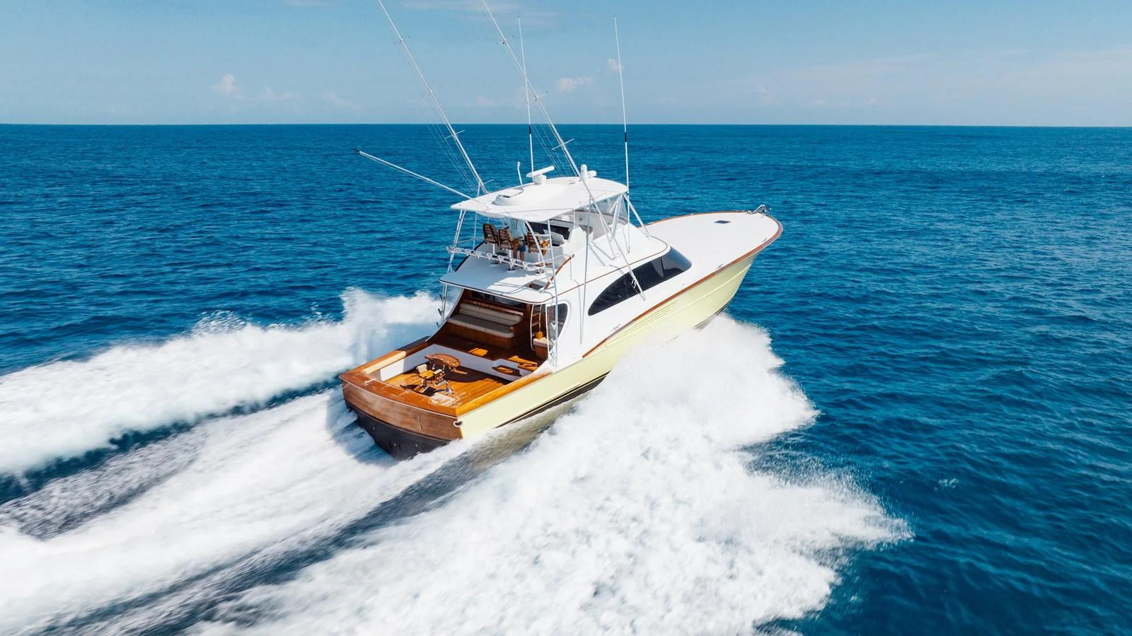 A sleek yacht cruises swiftly through the open ocean, showcasing its powerful design and elegant lines. aboard QUEEN BEE Yacht for Sale