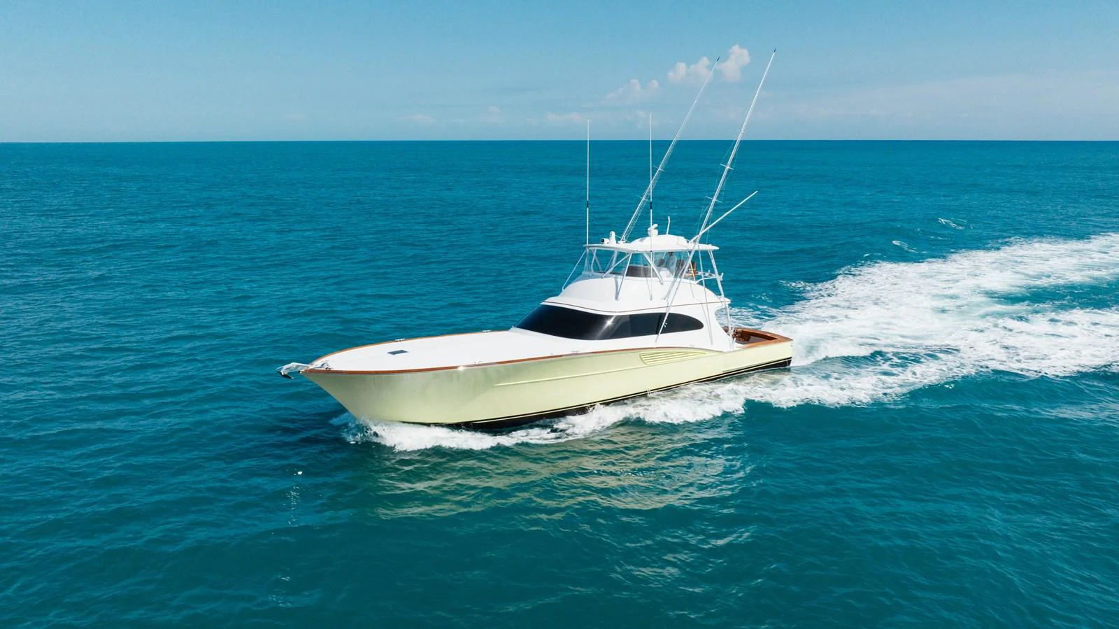 A sleek yacht cruises through the open sea, showcasing its elegant design and powerful performance. aboard QUEEN BEE Yacht for Sale