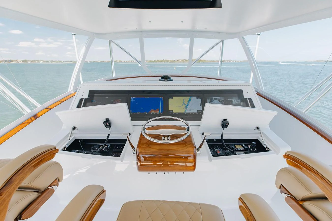 The helm station offers a panoramic view with state-of-the-art navigation equipment. aboard QUEEN BEE Yacht for Sale