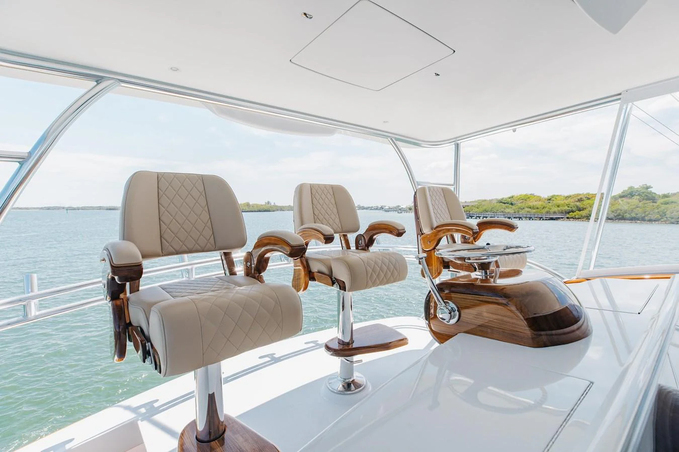 The helm area features luxurious seating with a panoramic view of the water. aboard QUEEN BEE Yacht for Sale
