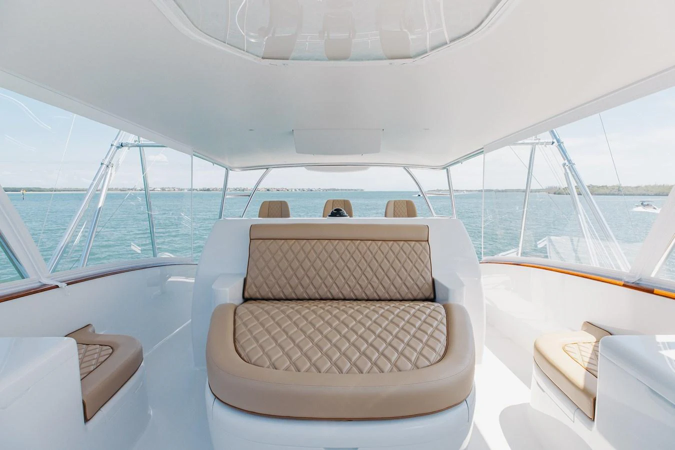 This yacht's helm area features luxurious seating with a panoramic view of the water. aboard QUEEN BEE Yacht for Sale