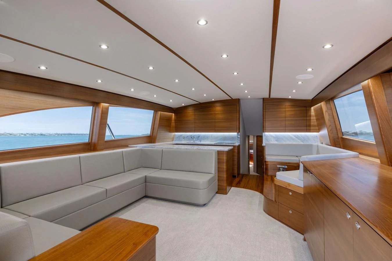 The salon features elegant wood paneling, plush seating, and expansive windows offering panoramic views. aboard QUEEN BEE Yacht for Sale