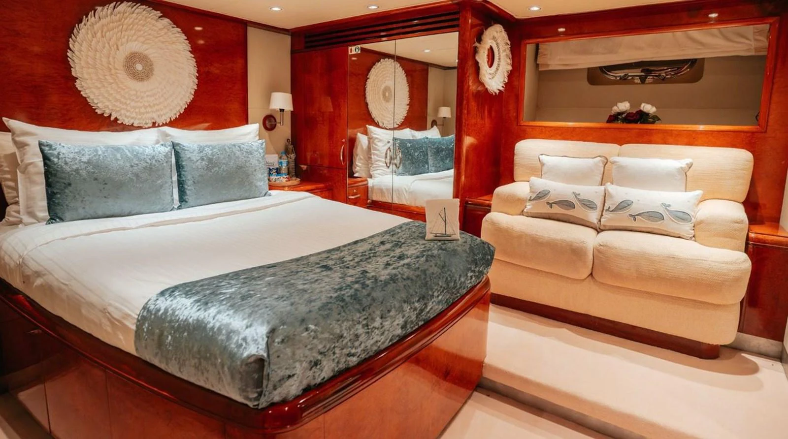 The stateroom features a plush bed with elegant bedding and a cozy seating area, creating a luxurious and inviting atmosphere. aboard THANDEKA Yacht for Sale